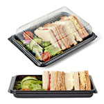 Set of 50 mini black platter bases with 50 clear lids from Platterplus, perfect for serving small food items or appetizers.